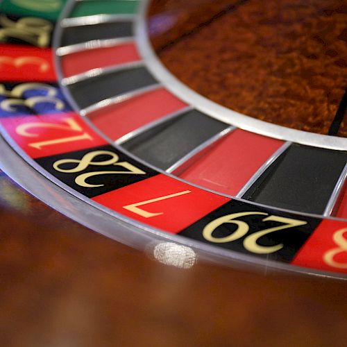 This image shows a section of a roulette wheel with numbers and colors red, black, and green, typically found in casinos.